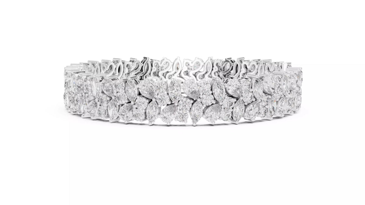 White gold wide diamond tennis bracelet side view with natural pear and marquise cut diamonds