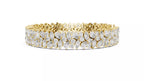 Yellow gold natural diamond tennis bracelet side view, pear and marquise cluster design